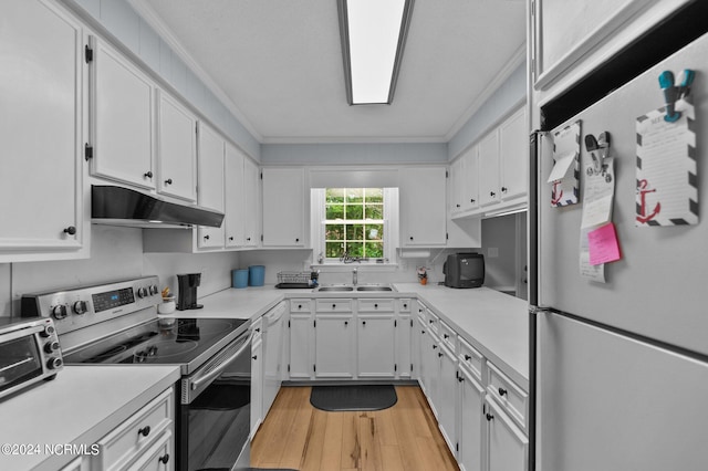 kitchen featuring white cabinets, ornamental molding, sink, appliances with stainless steel finishes, and light hardwood / wood-style floors