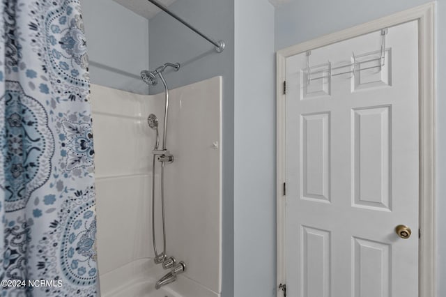 bathroom with shower / bath combo with shower curtain