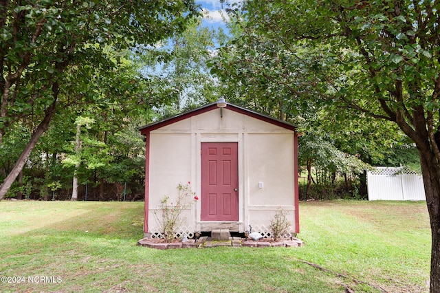 view of outdoor structure featuring a lawn