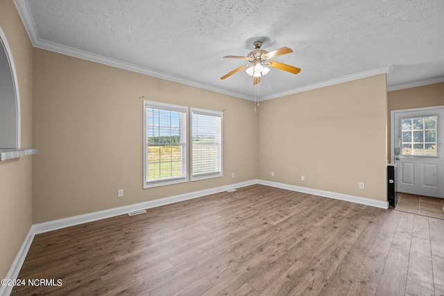 unfurnished room with ceiling fan, hardwood / wood-style flooring, ornamental molding, and a textured ceiling