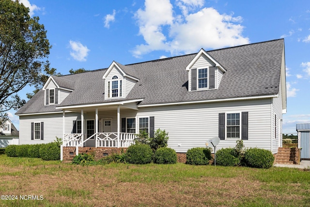 cape cod house with a porch and a front lawn