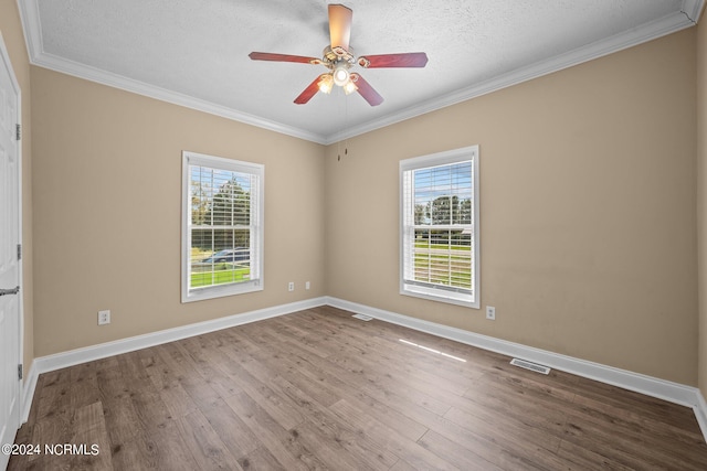 empty room featuring a healthy amount of sunlight, ceiling fan, light hardwood / wood-style floors, and a textured ceiling