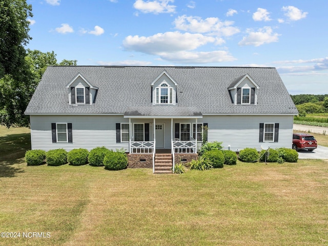 cape cod home featuring a front lawn and a porch