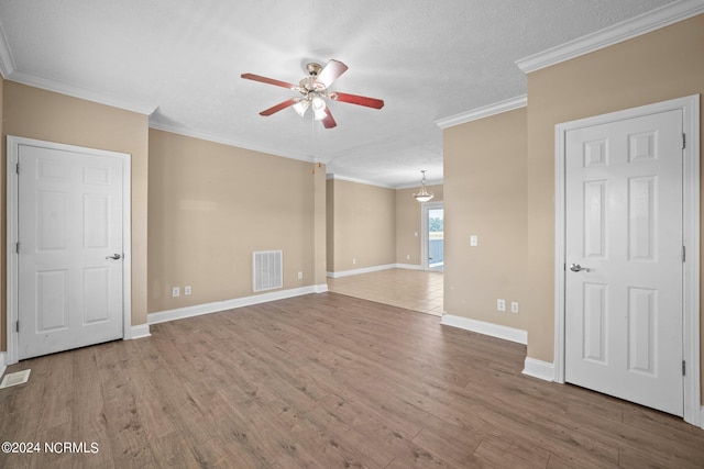 unfurnished room featuring hardwood / wood-style flooring, crown molding, ceiling fan, and a textured ceiling