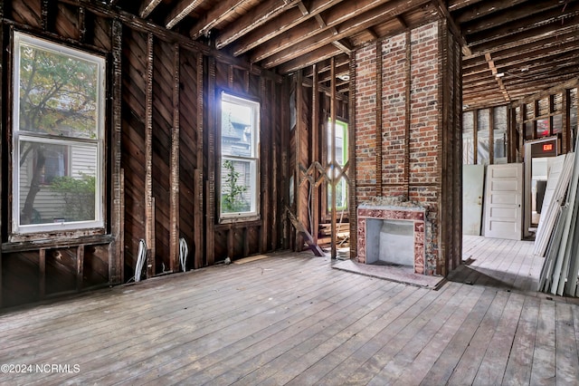 misc room with a large fireplace and wood-type flooring