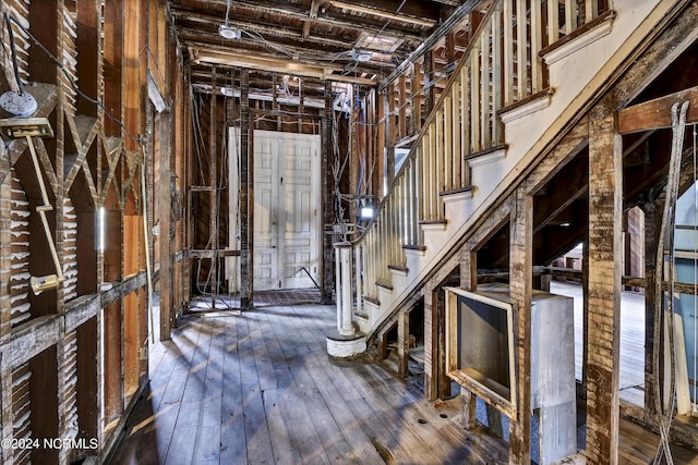 miscellaneous room with hardwood / wood-style floors and stairs