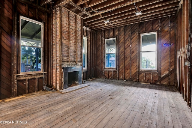 miscellaneous room featuring a large fireplace and hardwood / wood-style flooring