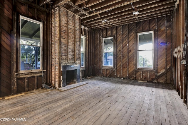 misc room with a large fireplace and wood-type flooring