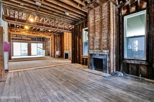 miscellaneous room featuring hardwood / wood-style flooring and a large fireplace