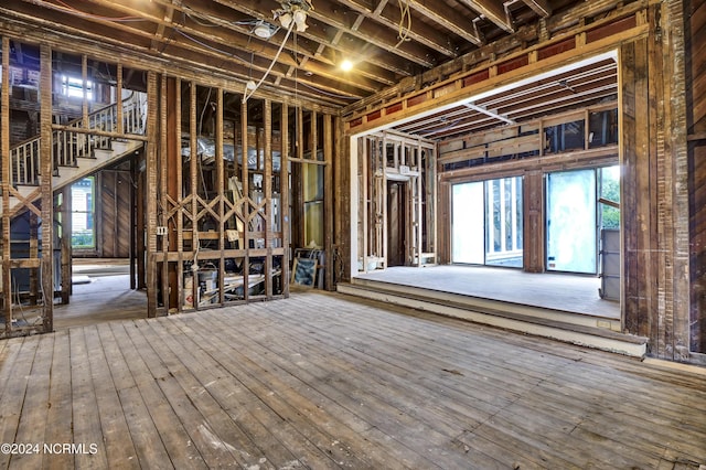 miscellaneous room featuring wood-type flooring and stairs