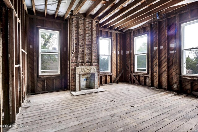 unfurnished living room featuring hardwood / wood-style flooring and a healthy amount of sunlight