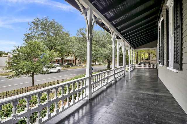 wooden terrace featuring covered porch