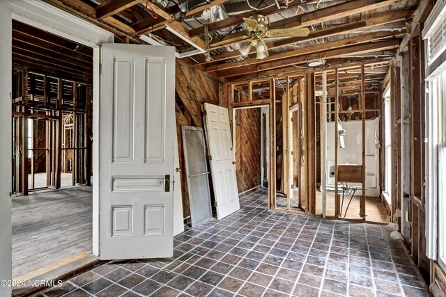 miscellaneous room featuring stone finish flooring and a ceiling fan