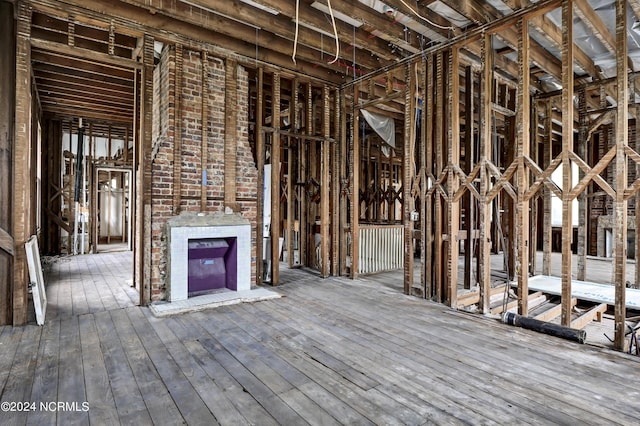 misc room with hardwood / wood-style flooring and a fireplace