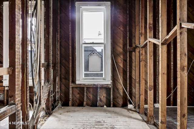misc room featuring wooden walls