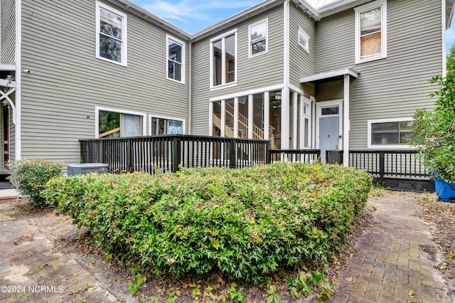 rear view of property featuring central AC unit