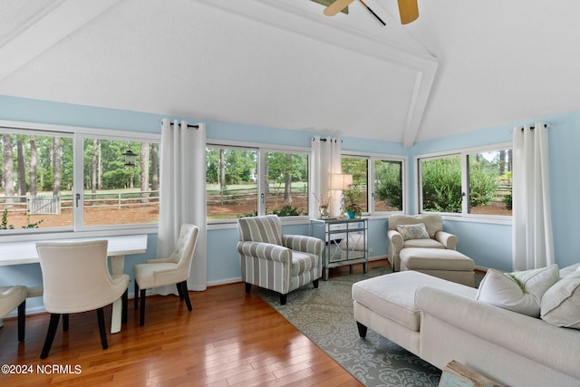 sunroom featuring lofted ceiling with beams and ceiling fan