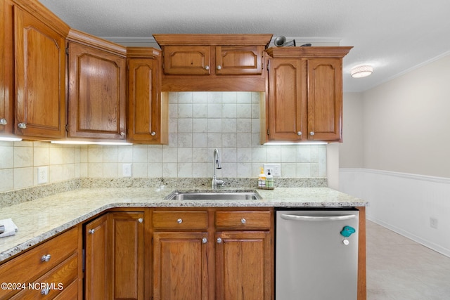 kitchen with decorative backsplash, ornamental molding, sink, and stainless steel dishwasher