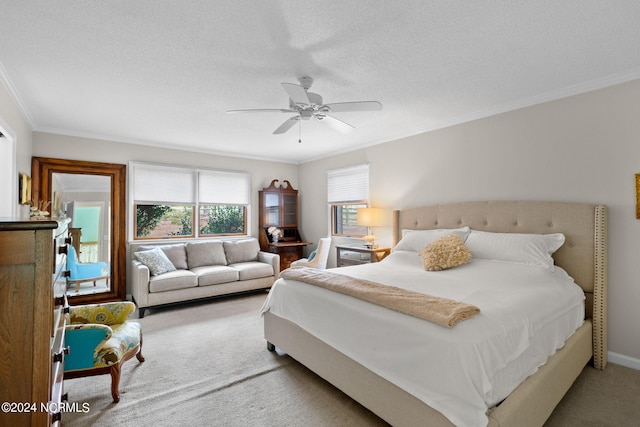 carpeted bedroom featuring ceiling fan, a textured ceiling, and ornamental molding