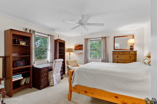 bedroom featuring light carpet, crown molding, and ceiling fan