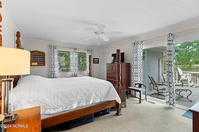 carpeted bedroom featuring ornamental molding, a textured ceiling, and ceiling fan