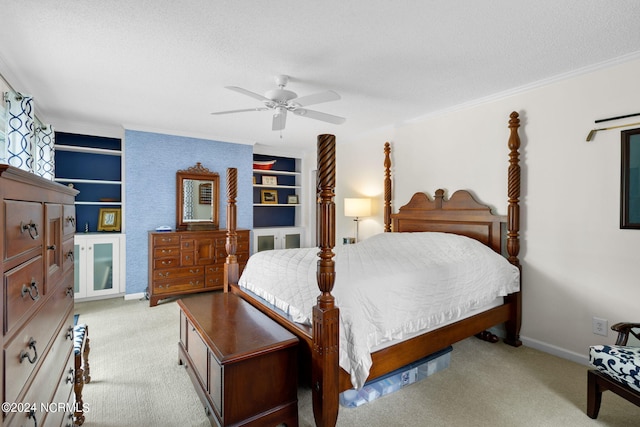 bedroom featuring a textured ceiling, ceiling fan, and light colored carpet