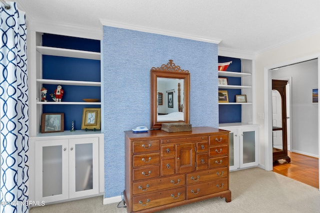 carpeted bedroom featuring ornamental molding and a textured ceiling