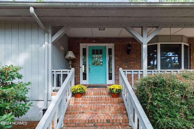 view of exterior entry with covered porch