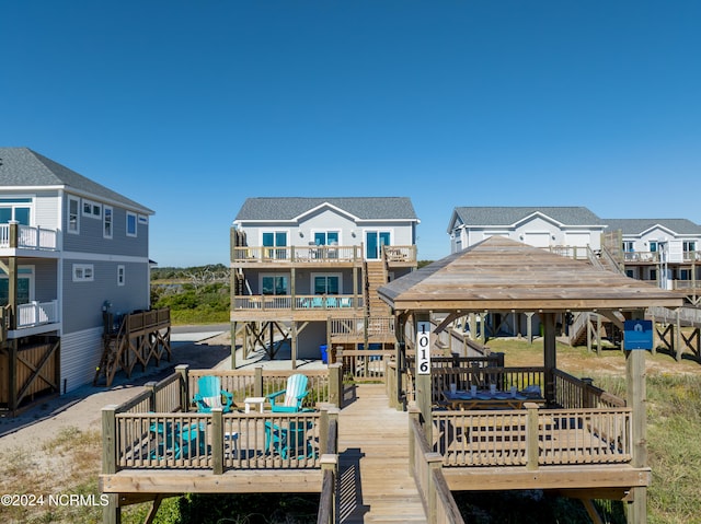 exterior space featuring a balcony and a wooden deck