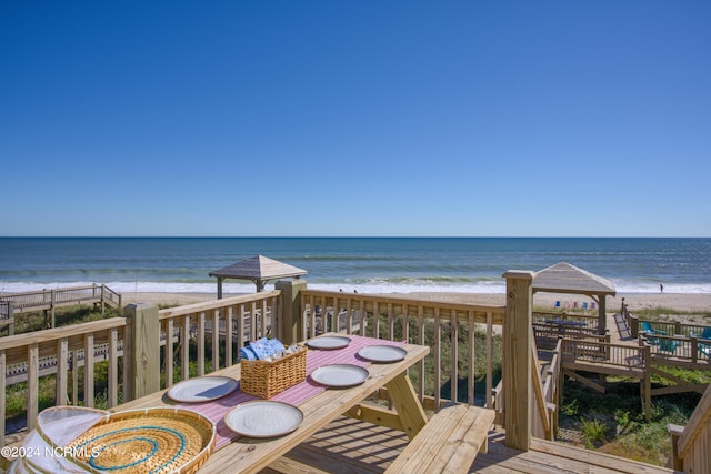 exterior space featuring a view of the beach, a water view, and a gazebo