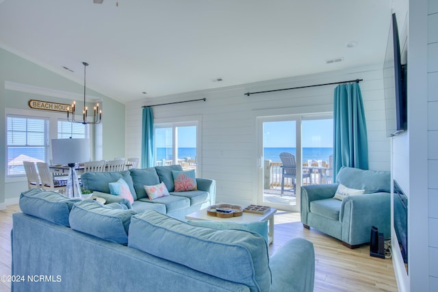 1016 New River Inlet Rd, North Topsail Beach, NC 28460 - living area with visible vents, light wood finished floors, a notable chandelier, and vaulted ceiling