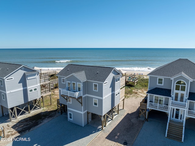 birds eye view of property featuring a water view and a beach view