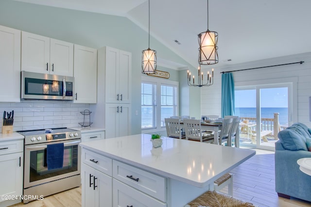 1016 New River Inlet Rd, North Topsail Beach, NC 28460 - kitchen featuring tasteful backsplash, appliances with stainless steel finishes, plenty of natural light, and lofted ceiling