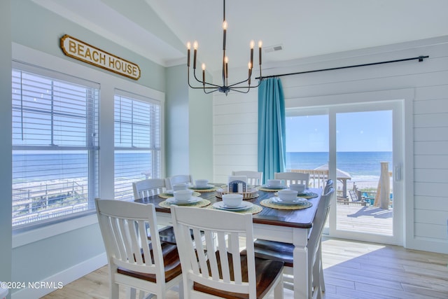 1016 New River Inlet Rd, North Topsail Beach, NC 28460 - dining area with wood finished floors, an inviting chandelier, visible vents, and a water view