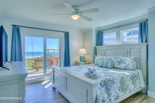 bedroom featuring light hardwood / wood-style flooring, access to exterior, and multiple windows