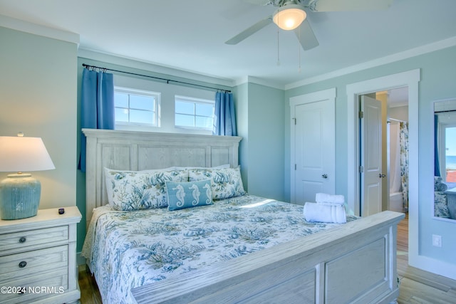 bedroom with light wood-type flooring, crown molding, ceiling fan, and ensuite bathroom