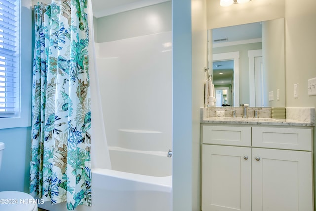 full bathroom with ornamental molding, shower / bathtub combination with curtain, vanity, and toilet