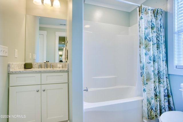 full bathroom featuring shower / bath combo with shower curtain, vanity, and toilet