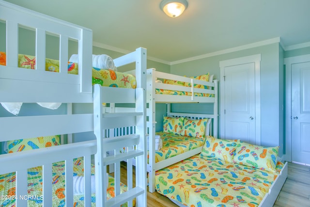 bedroom featuring hardwood / wood-style flooring and ornamental molding