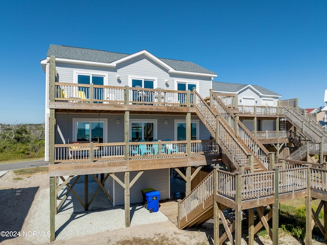 rear view of house featuring a wooden deck