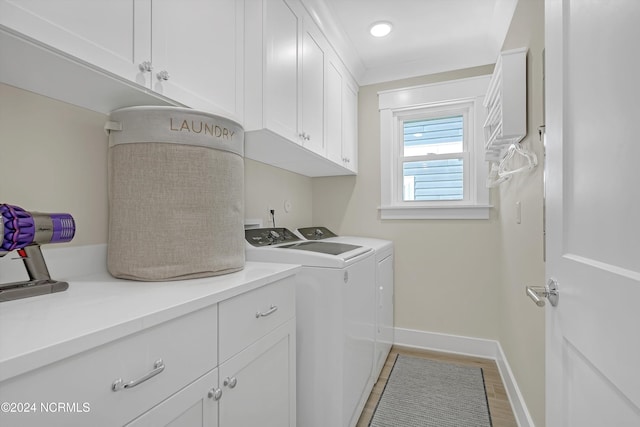 washroom with cabinets, separate washer and dryer, and hardwood / wood-style floors