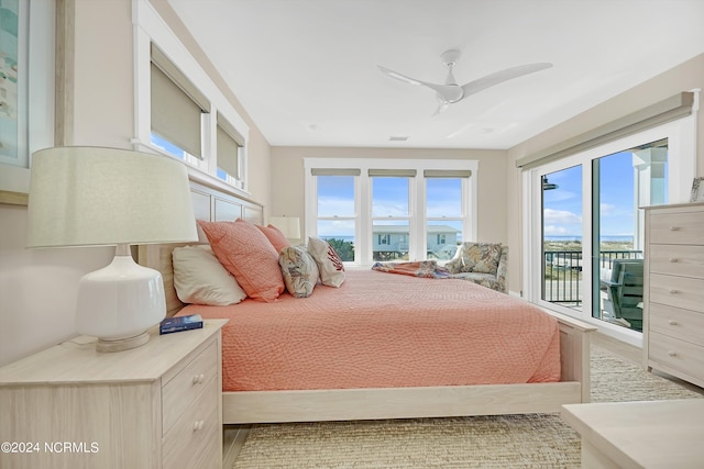 bedroom with access to exterior, multiple windows, and ceiling fan