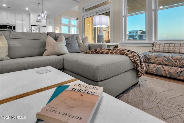 living room featuring a notable chandelier and a healthy amount of sunlight