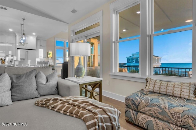 living room featuring a water view and hardwood / wood-style flooring