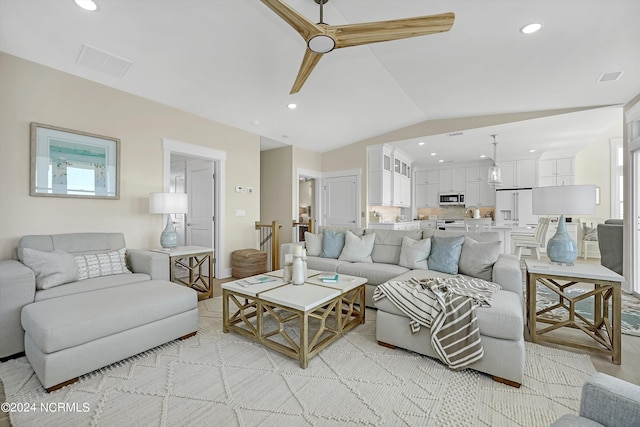 living room featuring vaulted ceiling and ceiling fan