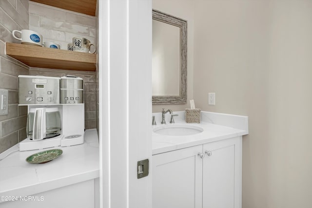 bathroom featuring vanity and backsplash