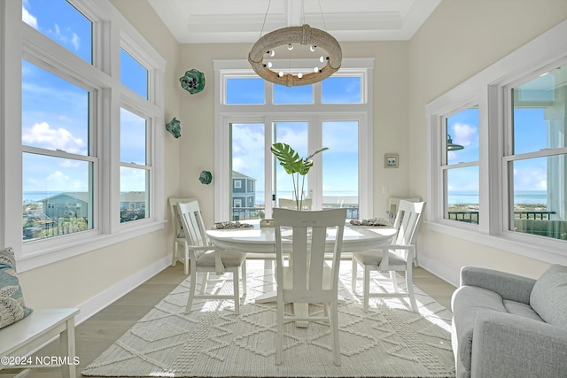 sunroom featuring a chandelier