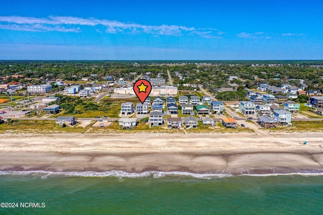 birds eye view of property featuring a water view and a view of the beach