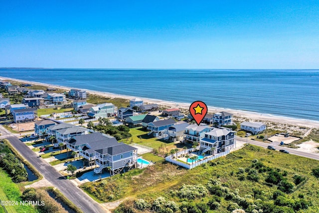 aerial view with a water view and a beach view