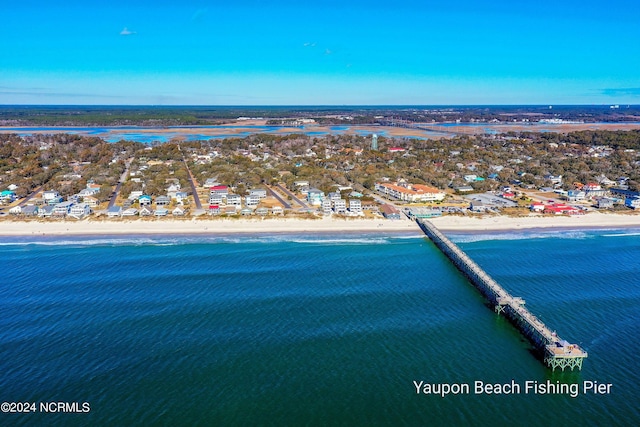 birds eye view of property featuring a water view and a beach view